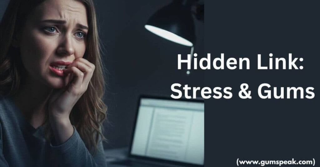A stressed woman working at a laptop touching her jaw, illustrating the connection between stress and gum health and dental pain.